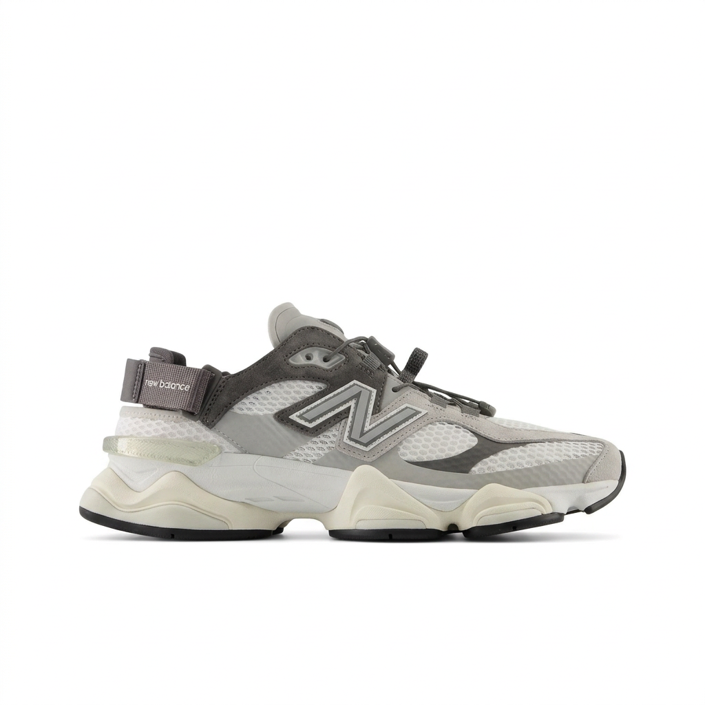 New Balance 9060 grey and cream sneaker with cord lacing and heel strap, side view on white