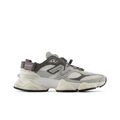 New Balance 9060 grey and cream sneaker with cord lacing and heel strap, side view on white